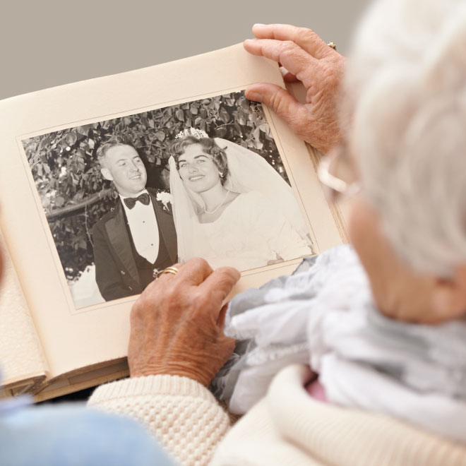 Senior woman and man looking at an old photo album