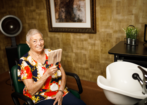 Resident admiring her new haircut in our salon