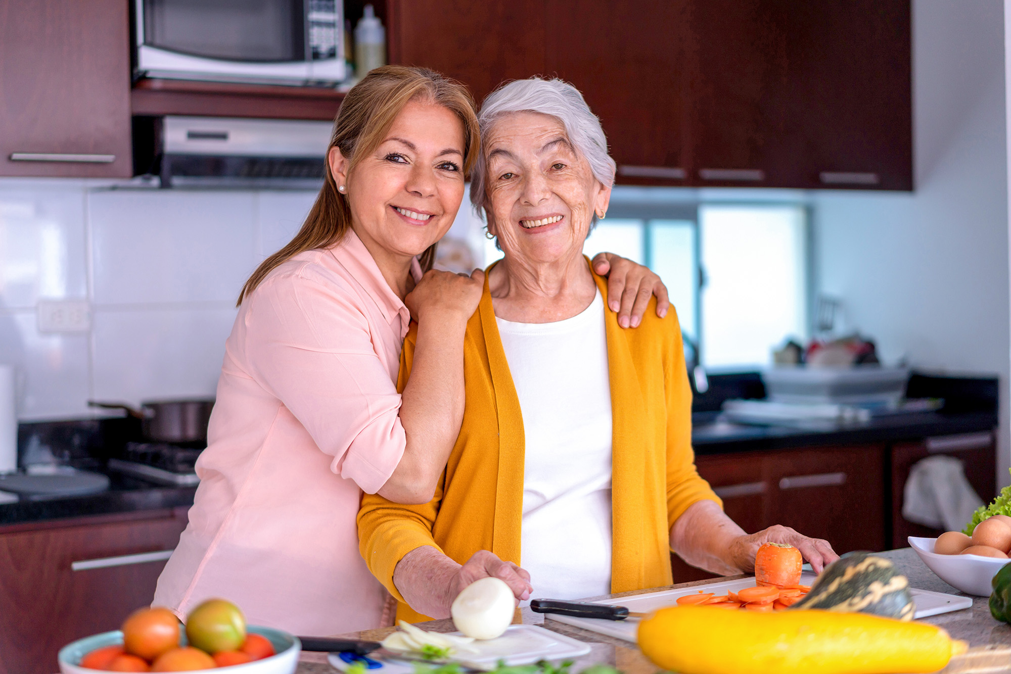 Woman with her senior mother in the kitchen Free Guide for Senior Living